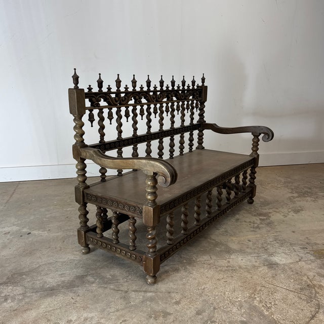 This exceptional late 19th-century Renaissance Revival settee is masterfully crafted in walnut and distinguished by its...