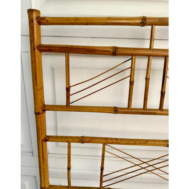 This vintage bamboo headboard dates to the 1970s and features an elegant geometric fretwork design crafted entirely from...