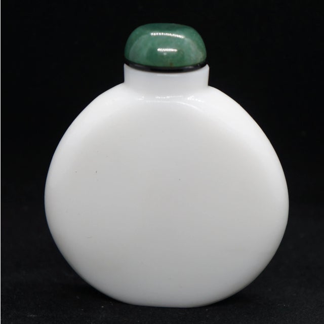The flattened round shape of this bottle with the sides tapering to a mere sliver is quite unusual. The sloping shoulder...