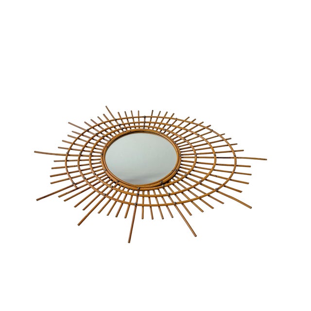Large elegant asymmetrical French Rattan Mirror in the style of Louis Sognot, 1950-1960, France. The mirror’s frame is...