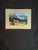 Elegant framed landscape photograph featuring a scenic Dolomites mountain range with snow-capped peaks, a lush green...