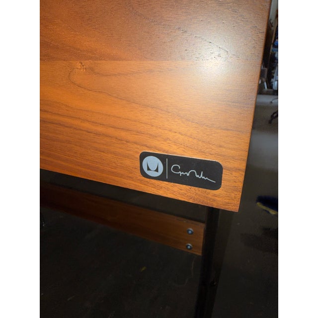 The Swag Leg Desk, designed by George Nelson in 1958, perches lightly on signature sculptural legs stabilized by a solid...
