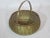 This is a round bombay shaped, solid brass woven basket with swing handle.