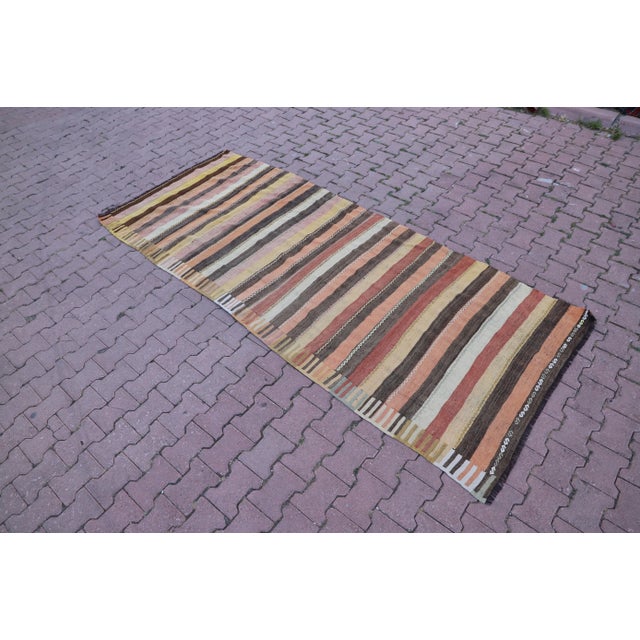 1970s Turkish Antique Striped Hand Knotted Kilim Rug Size: 4 x 9.7 ft (123 X 296 cm) 48 x 117 inches Color: Red, Tan,...