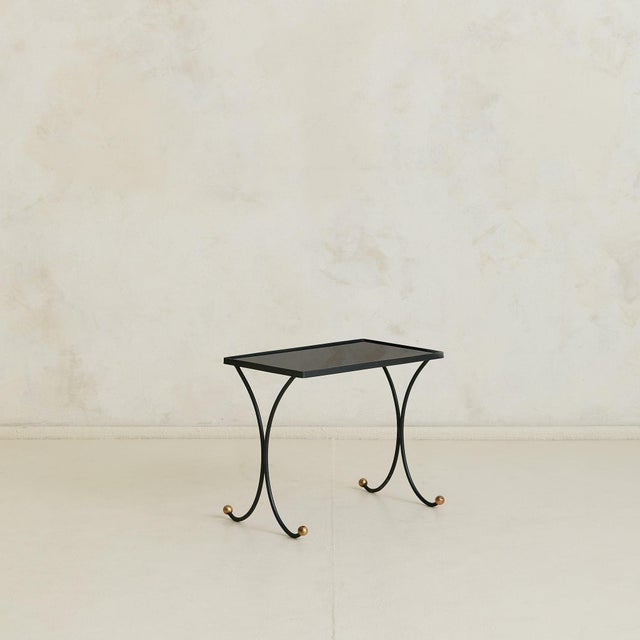 A trio of French nesting tables from the 1950s, in the manner of Jean Royère. Each table is composed of a delicate iron...