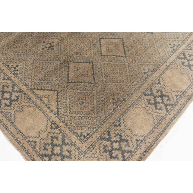 An early 20th century hand-knotted wool antique Persian rug. The design is influenced by the European Art Deco movements...