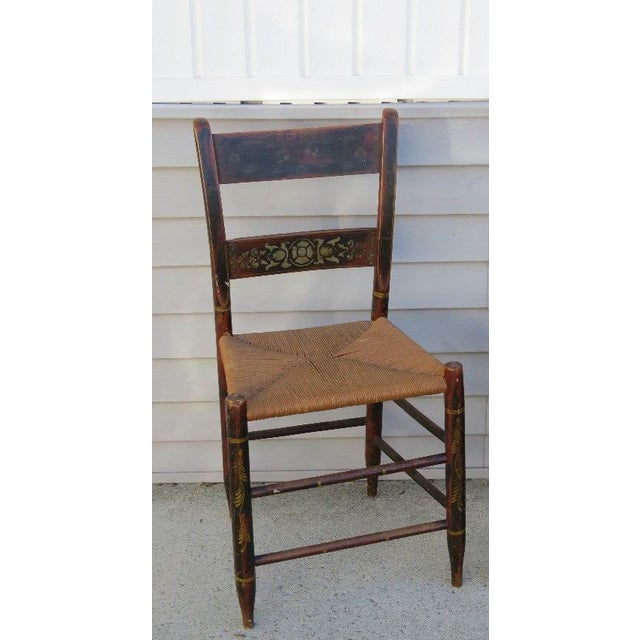 Antique Early 19th Century Hitchcock Style Stenciled Side Chair with Woven Rush Seat This remarkable antique side chair is...