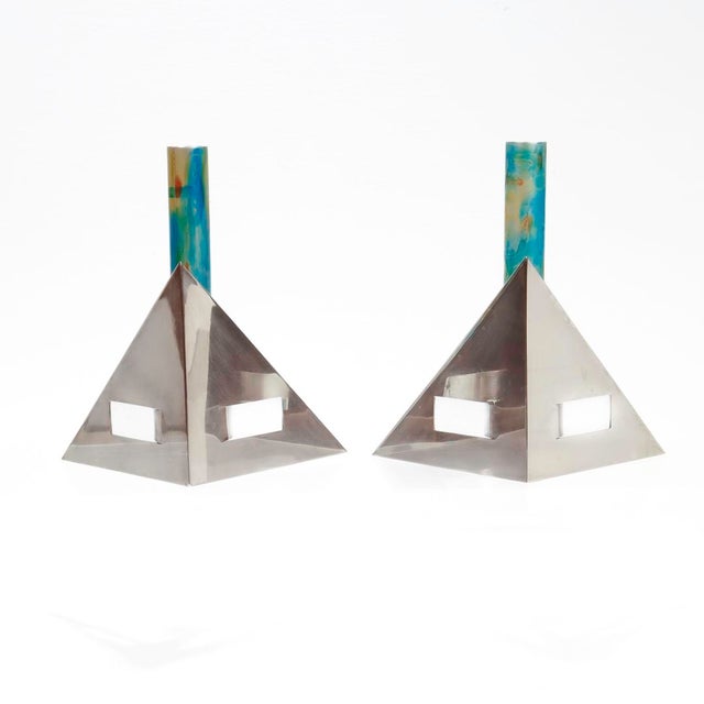 A fine pair of signed Modernist silver candlesticks. By Arie Ofir. In sterling silver with anodized aluminum central...