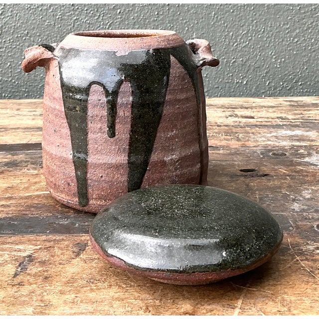 Discover the raw, organic beauty of this original studio pottery lidded jar, a striking example of 1970s artisanal...
