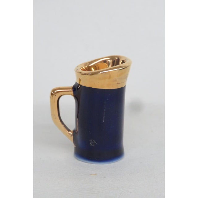 This lovely Limoges Miniature Pitcher is made of porcelain. This dainty porcelain collectible features a gorgeous, deep...