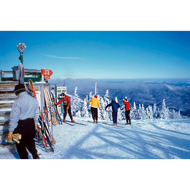 Preparing To Go by Toni Frissell Skiers gather near the top of the piste at the Stowe Mountain resort, Vermont, USA, 1955....