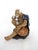 1980's fine Shiwan figure of an elderly white haired man perched on a rock with his wicker hat and drinking cup - probably...