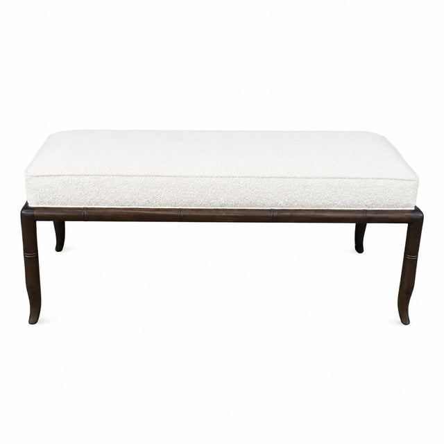 Mid century modern walnut bench with white Boucle upholstery. The bench is done is the manner of Robsjohn Gibbings . This...