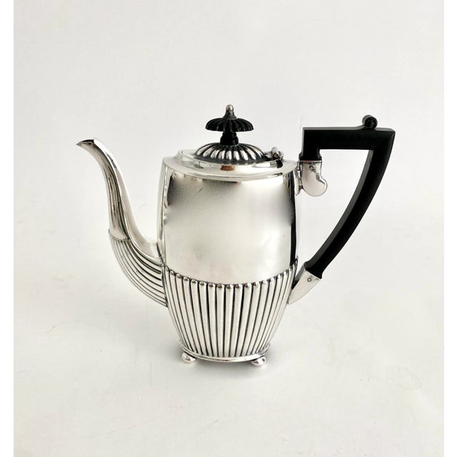 This Art Deco silverplate tea service features a Bakelite handle and finials and is marked for Israel Freeman & Sons...