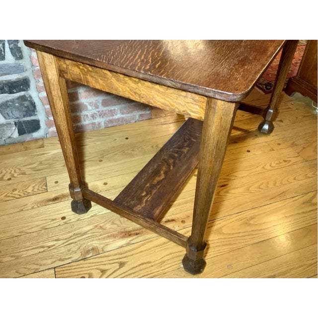 An antique Gothic Revival style rectangular library table with a highly-grained oak top, a single drawer, lower shelf,...