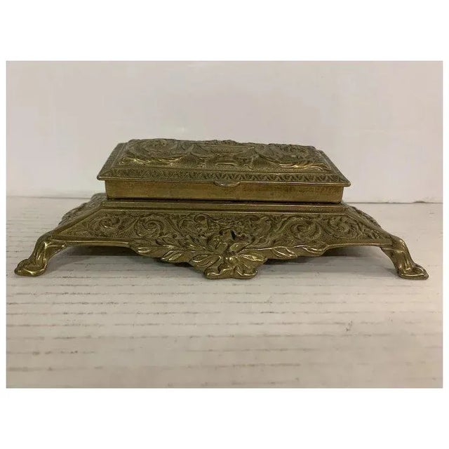 Beautifully decorated brass stamp box. W: 8.5" D: 5.5" H: 3"