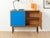 Wonderful dresser from the 1960s. Corpus in walnut veneer with two Formica-coated doors in blue, one shelf and new squared...