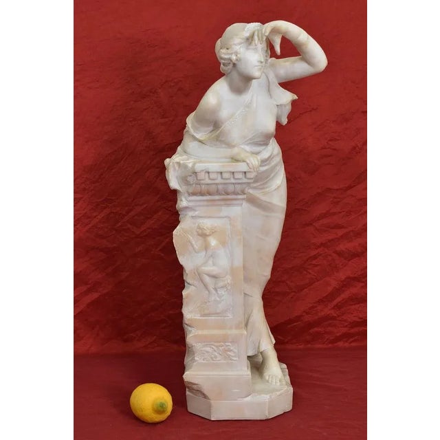 The Ancient Marble and Alabaster Sculptures category offers a refined Female Sculpture, a Young Woman leaning on a...