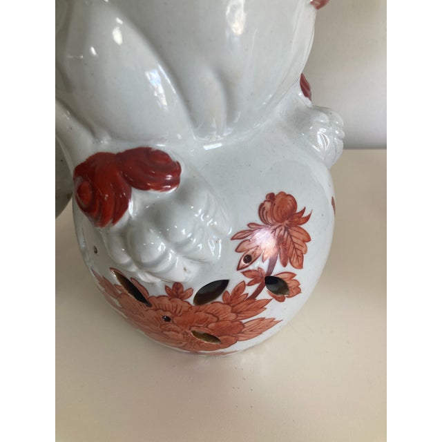Foo Dogs a pair of unusual Cinnamon and blanc glazed porcelain dogs. Both holding the Earth in reverse of each other. Add...