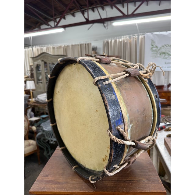 A striking mid-19th century brass rope-tension side drum, likely of European origin, featuring a beautifully aged brass...