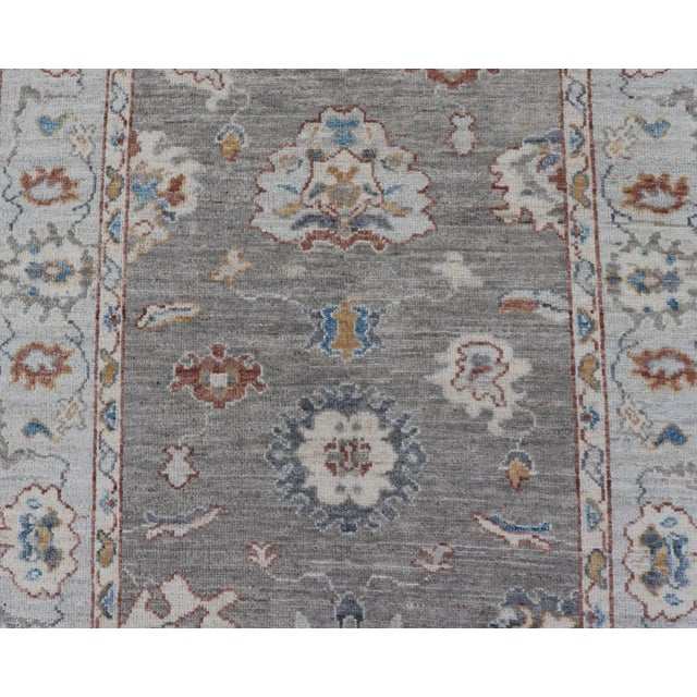 Floral Designed Oushak With Muted Background With Earthy Tones and Soft Blue For Sale - Image 4 of 13