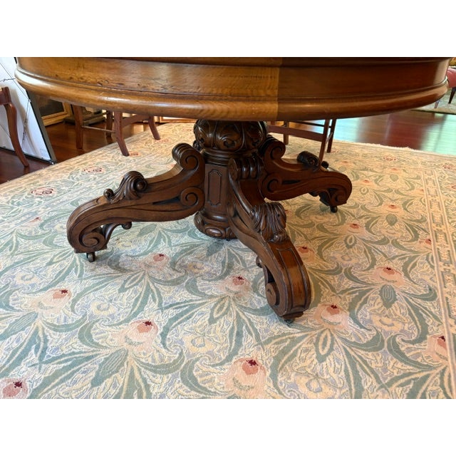Circa 1865 Beautiful Rococo walnut dining table with leafy scrolled split pedestal. This table has one of the best...