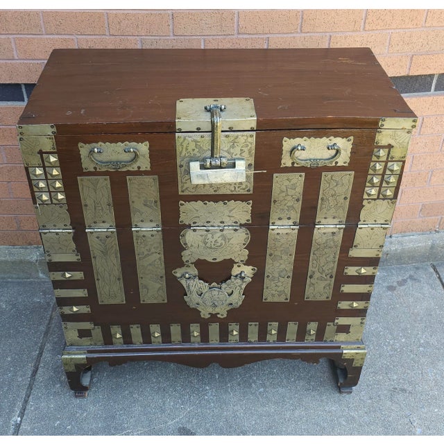 Antique Korean Tonsu chest, elaborately decorated with ornate brass mounts in various geometric forms, some of which have...