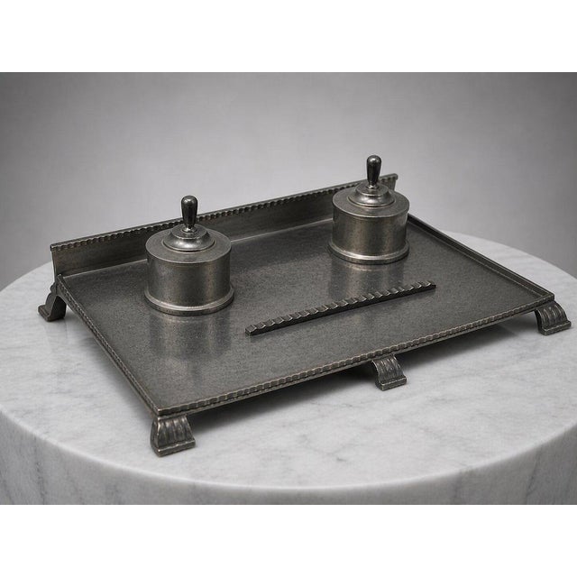 An elegant and architecturally refined double inkwell by renowned swedish silversmith cg hallberg, dating to 1931....