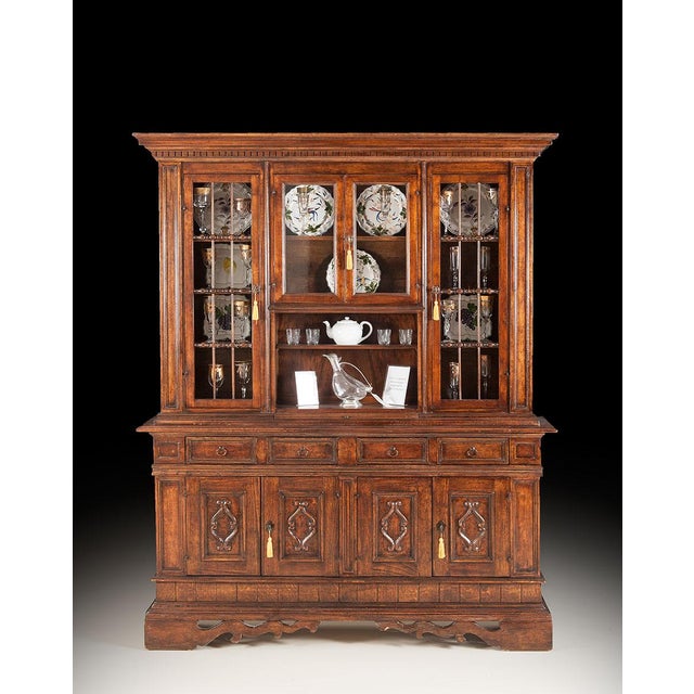 Crafted in Italy from solid walnut, this antique china cabinet combines impressive scale with practical storage. The upper...