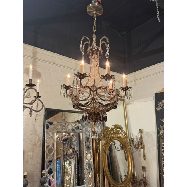 Italian Beaded and Amethyst Chandelier. An Italian beaded and amethyst chandelier sits at the intersection of Venetian...