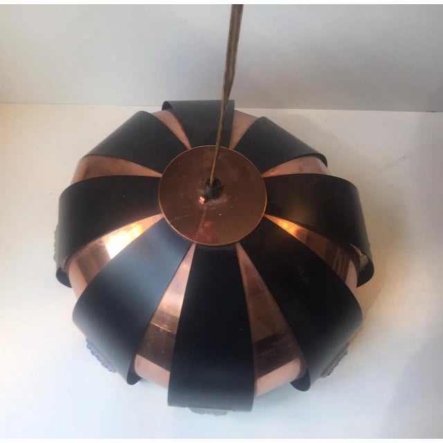 This pendant was designed by Werner Schou for Coronell elektro in Denmark. It is made from interchanging black and copper...