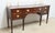 Mahogany Sideboard by Kindel. Store item #546. It features inlaid wood, three drawers and one storage compartment. The...