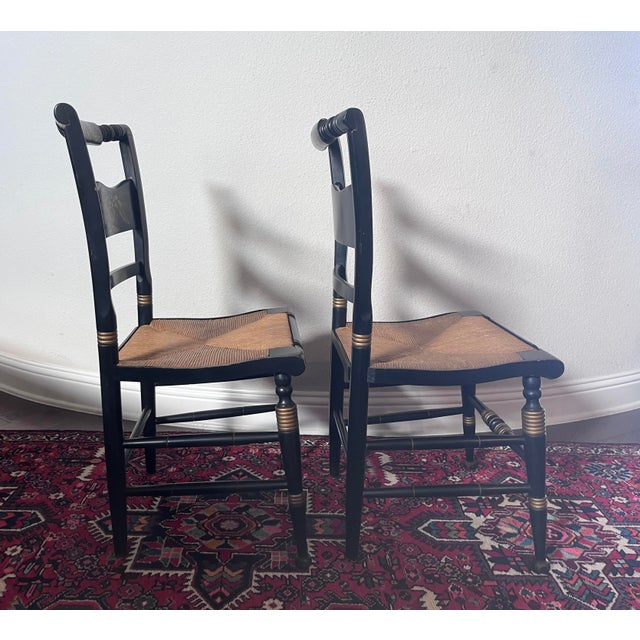 Set of 2 Hitchcock Style Stenciled, Black and Gold Painted Chairs, Rush Seat Total dimension: 17.5” width 17” depth 34.5”...