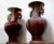 Two wonderful sang de boeuf vases in deep red and turquoise travel as a pair. One of the most memorable features of the...