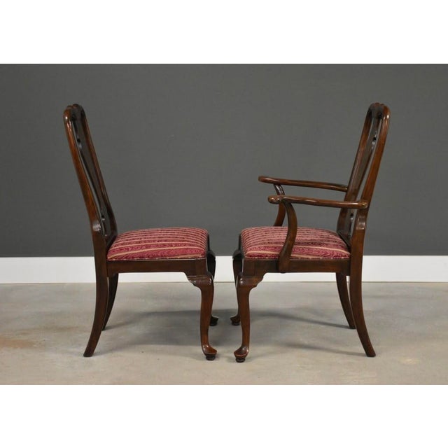 A set of six traditional Queen Ann style solid cherry dining chairs made by Ethan Allen. Circa 1980’s. Made in USA. Some...