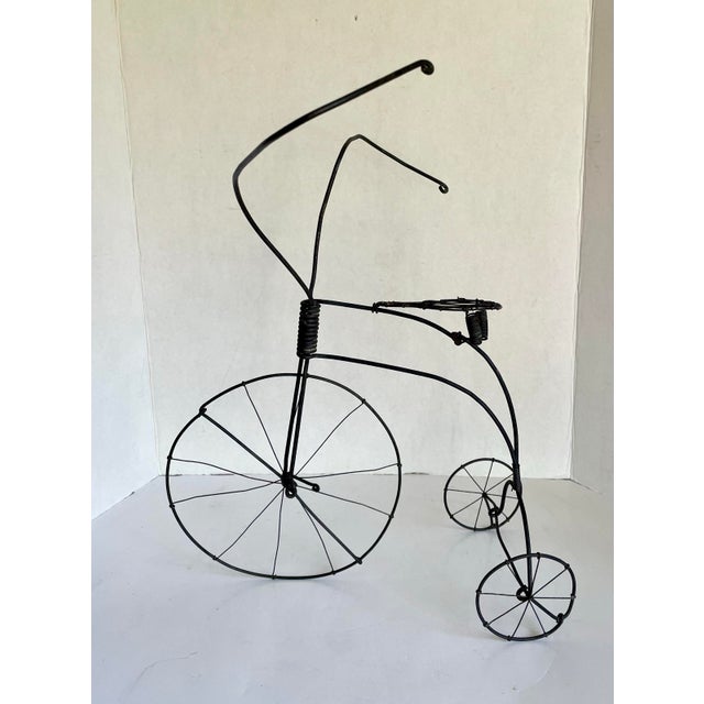 Here is a wonderfully handcrafted Folk Art tricycle sculpture, formed entirely from wire and metal and dating to the...