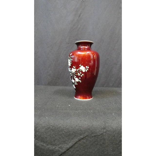 This vintage Japanese enamel art vase dates from the 1920’s/30’s. It displays a wonderful deep pomegranate red enamel...