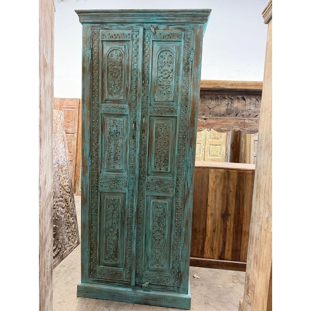 1920s Antique Blue Hand-Carved Armoire | Floral Carved Cabinet With Brass Stud Accents For Sale - Image 5 of 7