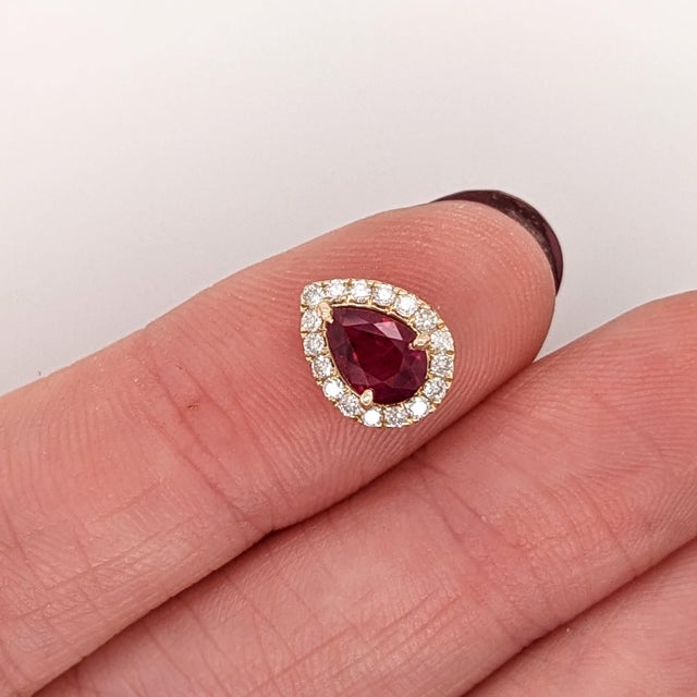 This beautiful pendant features a 0.72 carat pear cut ruby gemstone with natural earth mined diamonds all set in solid 14K...
