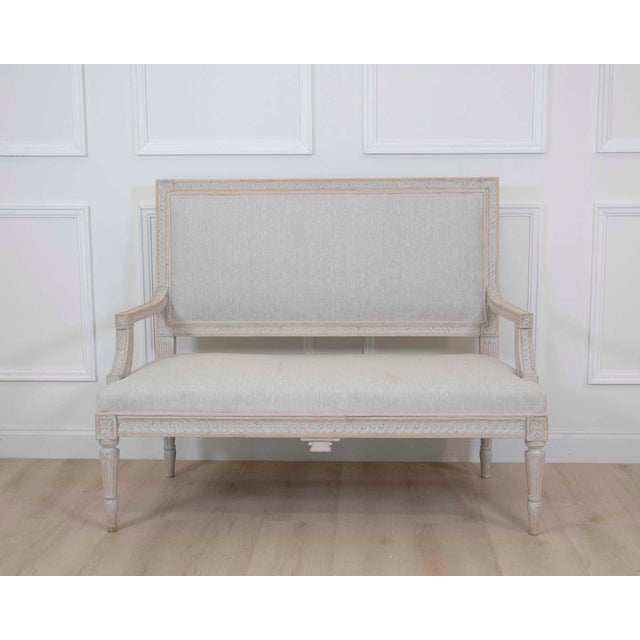 A refined Gustavian style settee dating to circa 1900 and featuring elegant neoclassical lines inspired by classic Swedish...