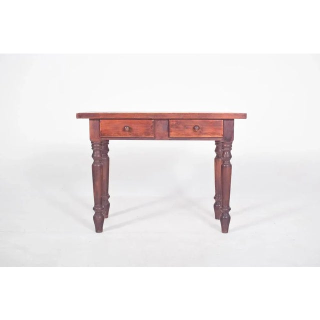 Pine kitchen table. with a flat rectangular top, simple edges and a sturdy structure, it is made up of four turned legs...