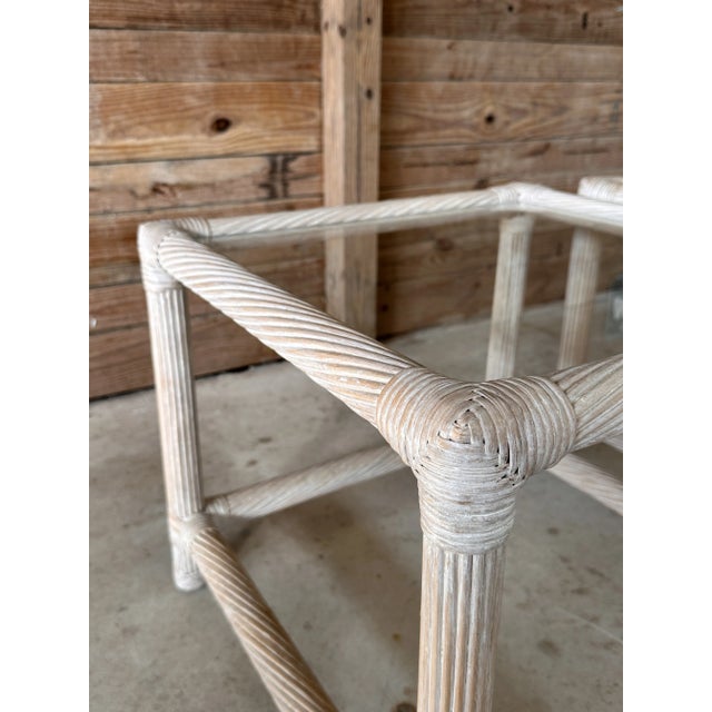 This stylish pair of 1980s twist pencil rattan side tables showcases an elegant cerused finish, emphasizing their textured...