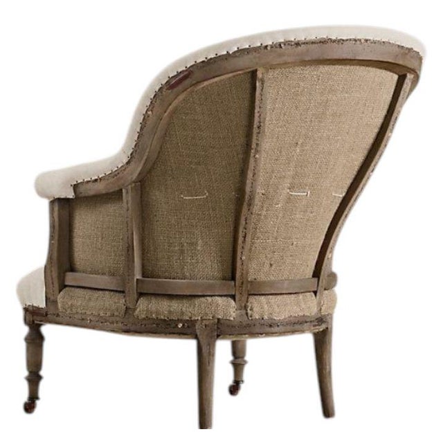 The deconstructed French barrel-back chair by Restoration Hardware Restoration Hardware celebrates the raw beauty of...