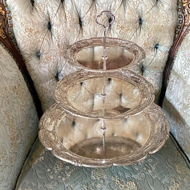 Three silver plated trays make this stand with top finial and silver plate base. The Bottom round tray is 14.5", the...