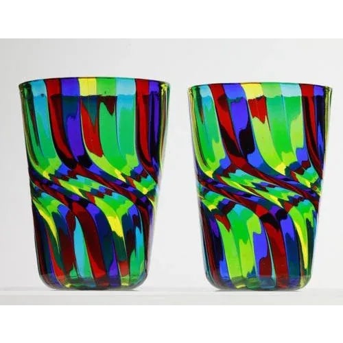 In this tumbler the traditional technique of straight canes receives an additional work. The glass before blowing is...