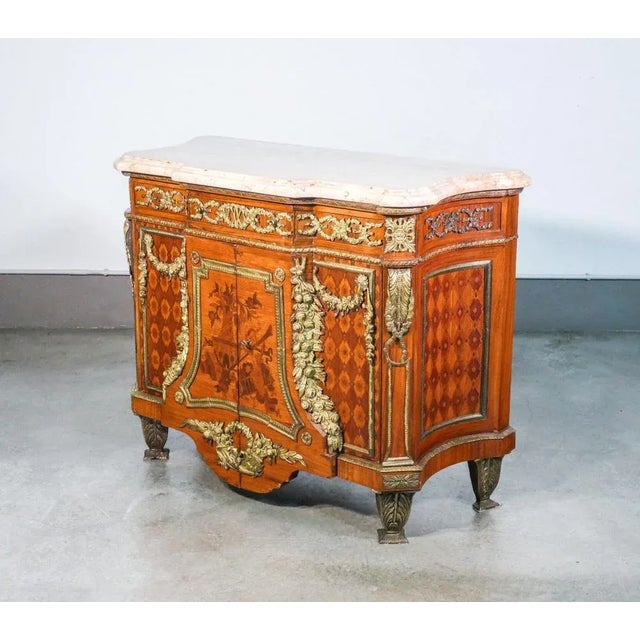 Louis XV style commodes / transition on the model made by Jean H. Riesner. Inlaid wood and bronze. Early twentieth century...