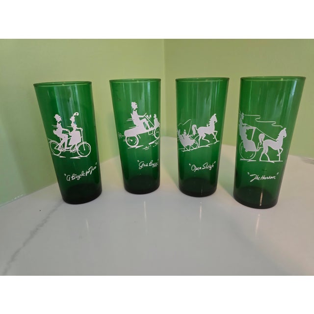 Step back in time with this charming set of Anchor Hocking four green glass tumblers adorned with nostalgic white...