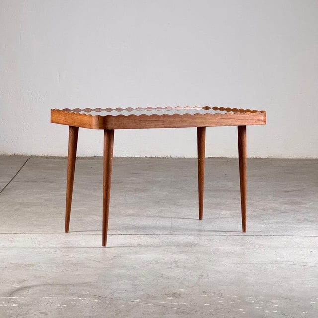 A stunning coffee table styled after Paolo Buffa for Permanente Mobili Cantù, showcasing the refined craftsmanship and...
