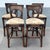 Stylish set of four vintage Boho Chic stools crafted from dark stained rattan with woven wicker accents. Each features an...