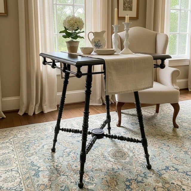 A classic antique stick and ball side table featuring a square top, turned legs, and distinctive stretcher base. This form...